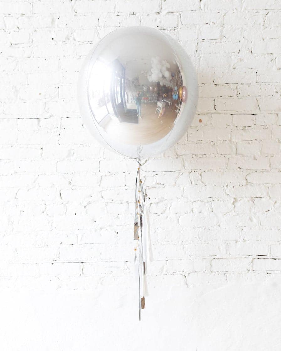 21in Silver Orb Foil Balloon and White, Grey & Silver Half-Tassel | Rental
